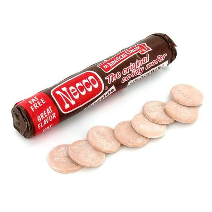 Angled overhead view of a roll of Necco Wafers with several pale pink wafer discs fanned out on a white background