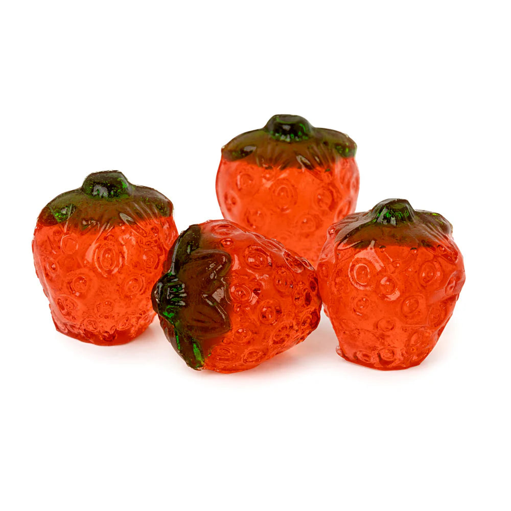 Four red strawberry-shaped gummy candies on a white background