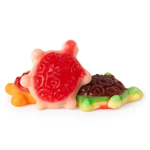 Colorful gummy turtle candies on a white background