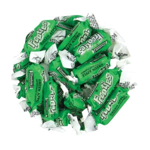 Bunch of green and white wrapped Frooties green apple candy on a white background