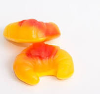 Two colorful croissant-shaped candies on a white background