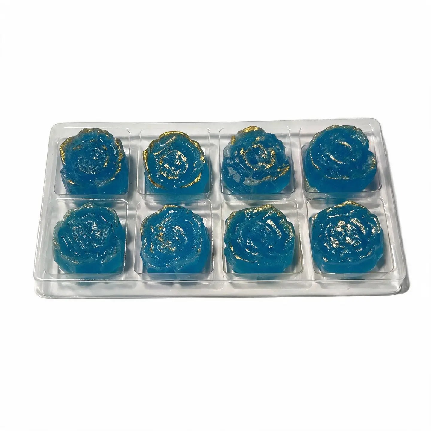 Eight blue rose-shaped gel candies in a clear plastic tray, with some pieces showing a gold glitter finish, on a white background