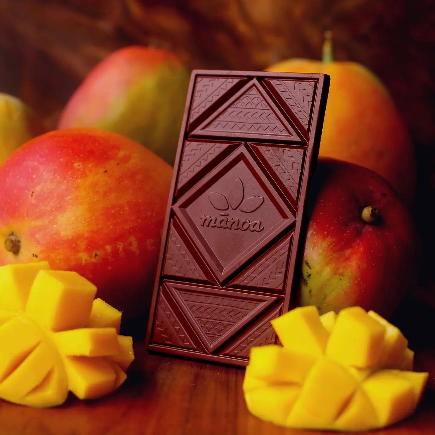 Chocolate bar with mangoes in the background