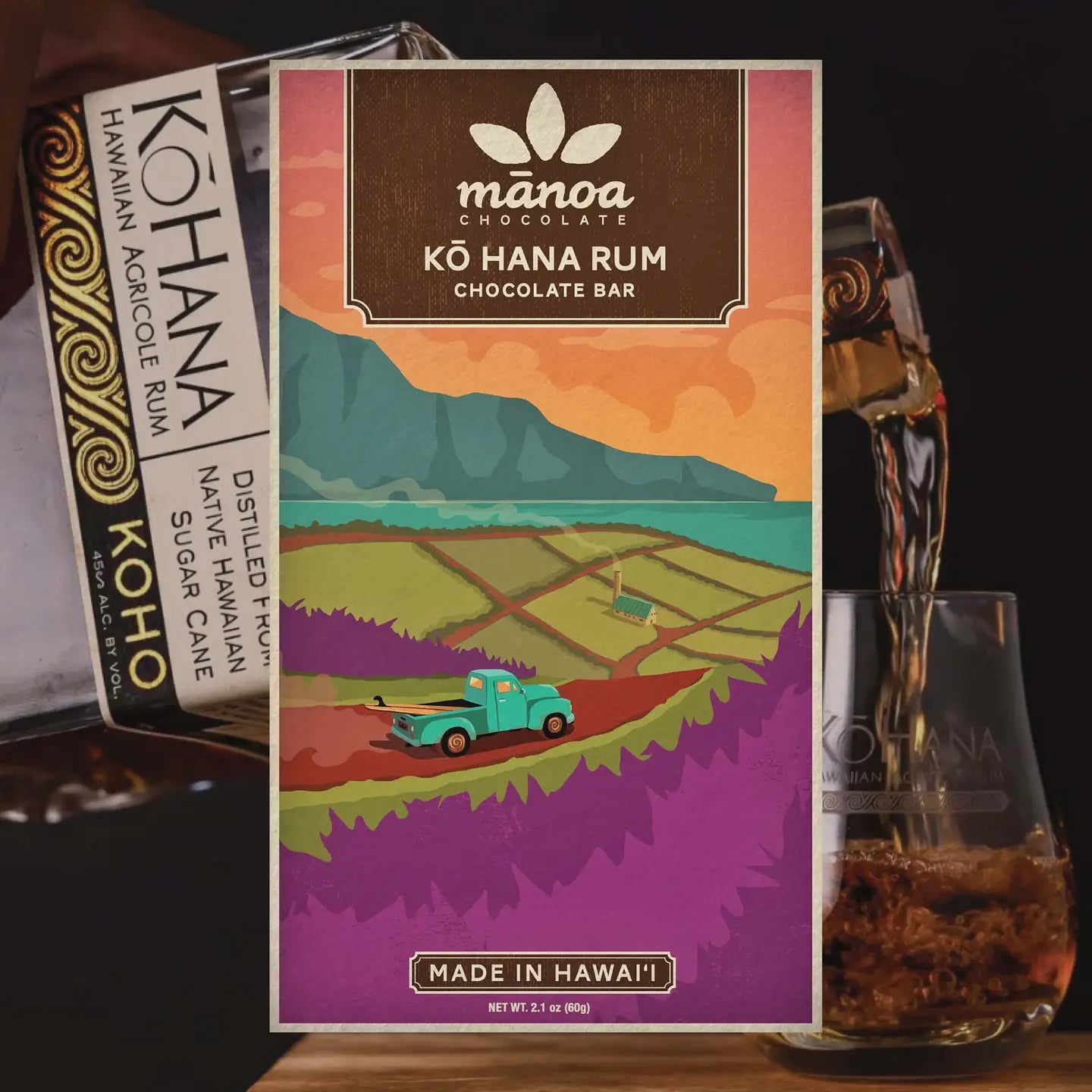 Manoa chocolate bar packaging with a scenic design, surrounded by rum bottles and a glass