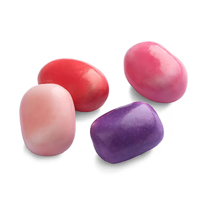 Four colorful candies in pink, red, purple, and orange on a white background
