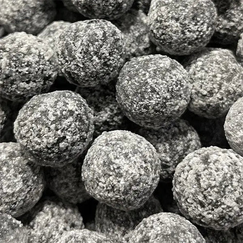 Close-up of the acid-coated black lemon sour candy from Mr Simms UK