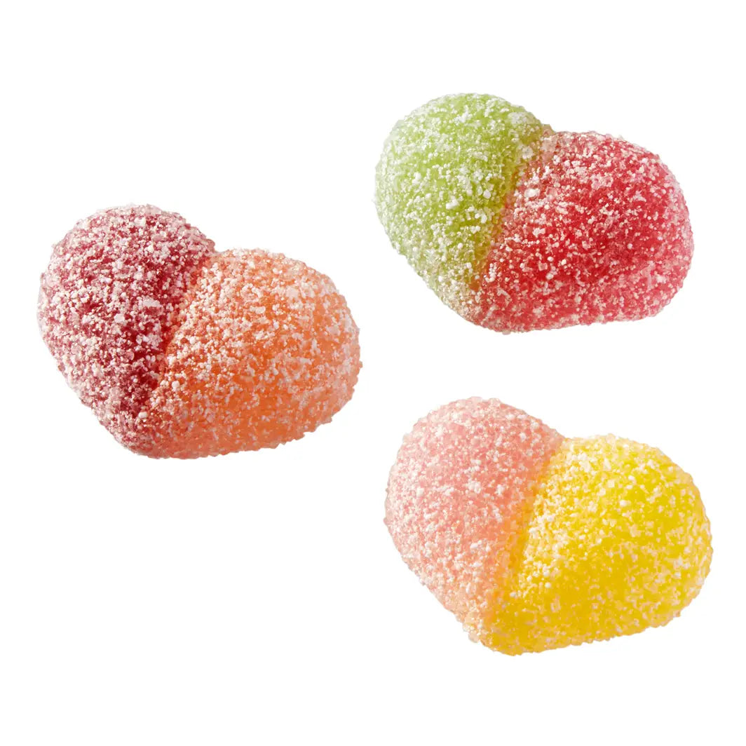 Three heart-shaped sugar-coated gummy candies in red-orange, green-red, and pink-yellow, arranged on a plain white background