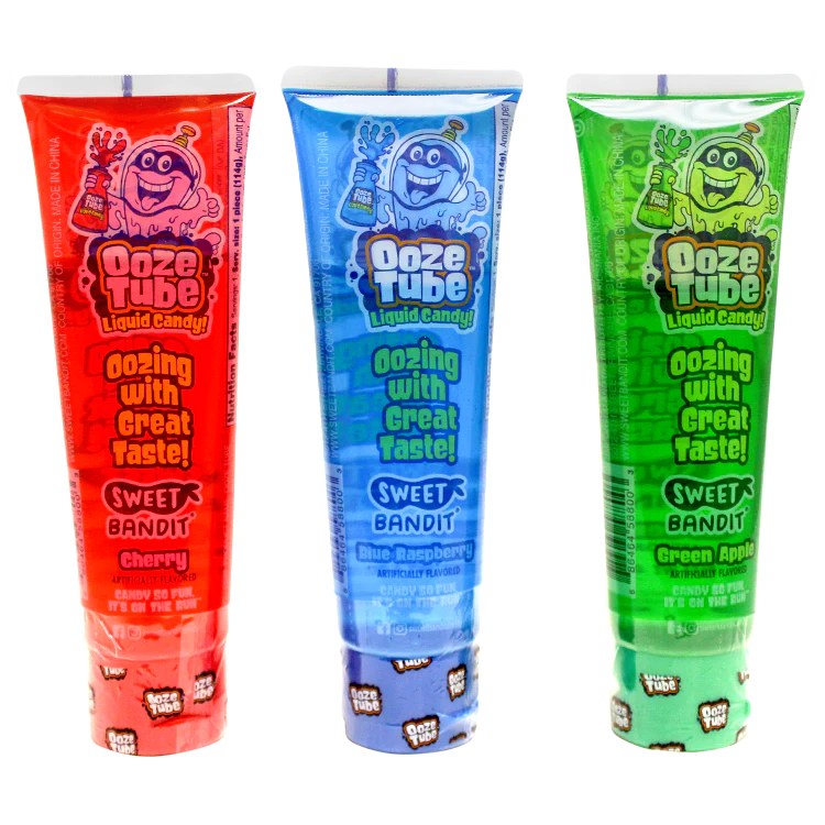 Three Ooze Tube candy packages in red, blue, and green on a white background