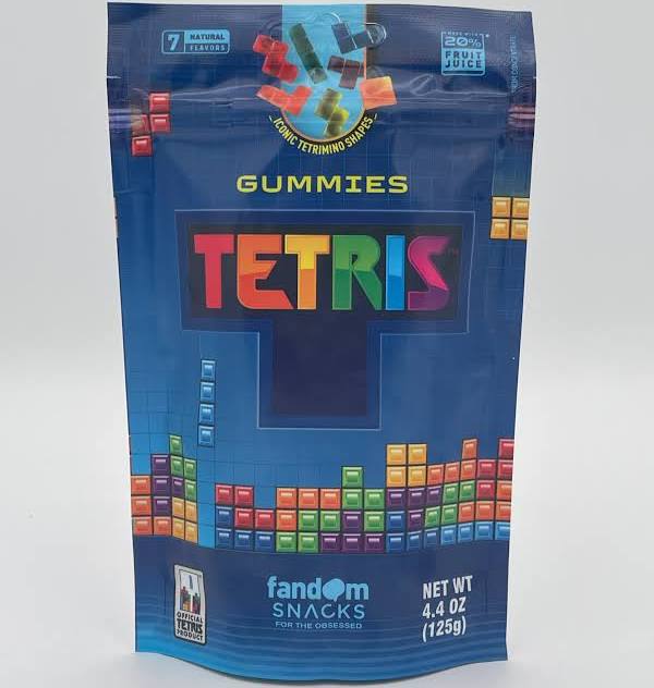 A blue stand-up pouch of Fandom Snacks Tetris Gummies, featuring colorful block graphics and the word 'TETRIS' in rainbow letters, on a light gray background