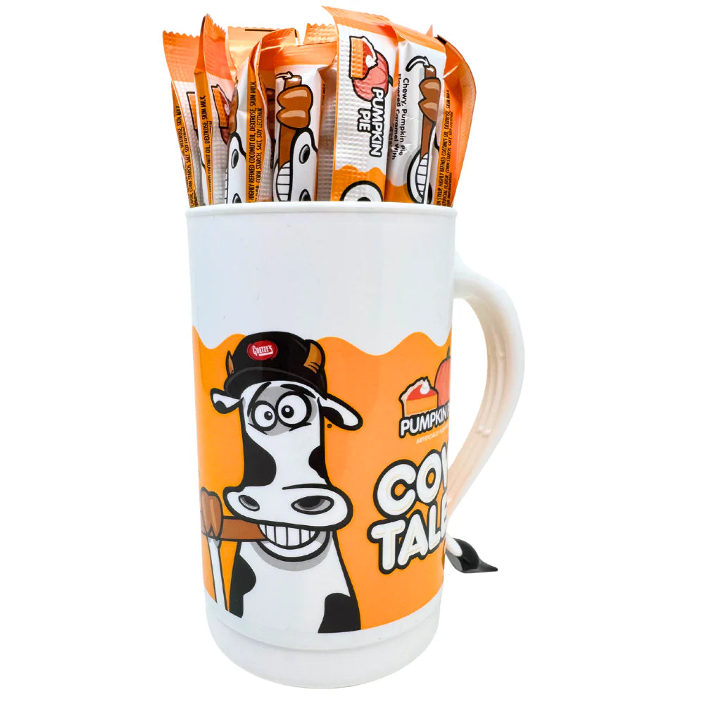 Mug with cartoon cow design filled with Pumpkin Pie spice packets on a white background