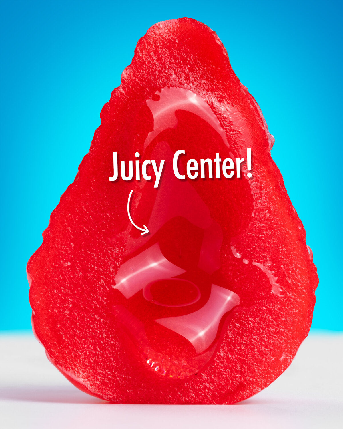 A bright red teardrop-shaped jelly candy with a glossy translucent center, shown on a blue and white background with the text 'Juicy Center!' overlaid on the image